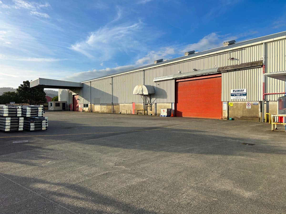 Warehouse exterior of White Lion at 38 East Street, industrial building with red door.