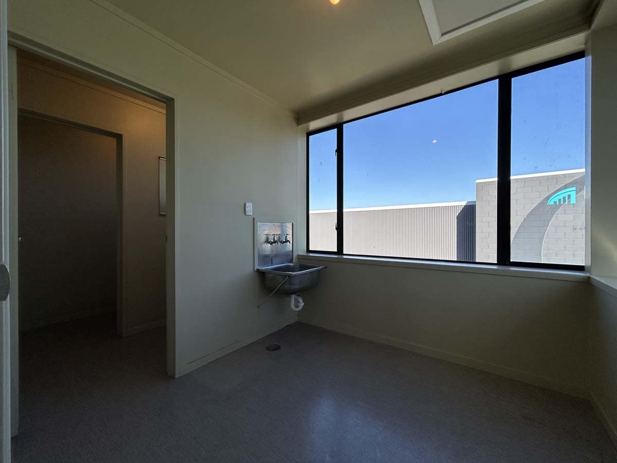 Bright interior room with large window and city view at 5 Clinton Street.