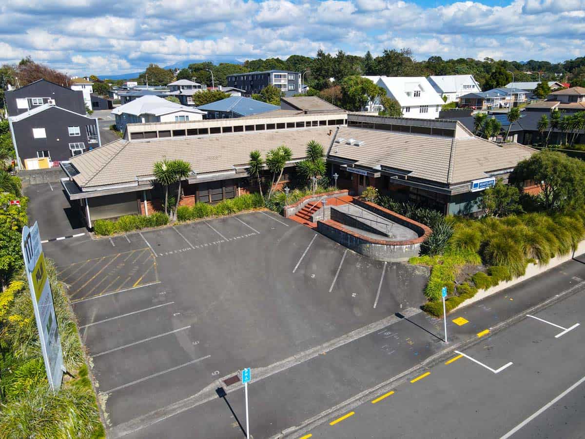 Aerial view of White Lion building at Powderham Business Centre with parking lot and surrounding nei.