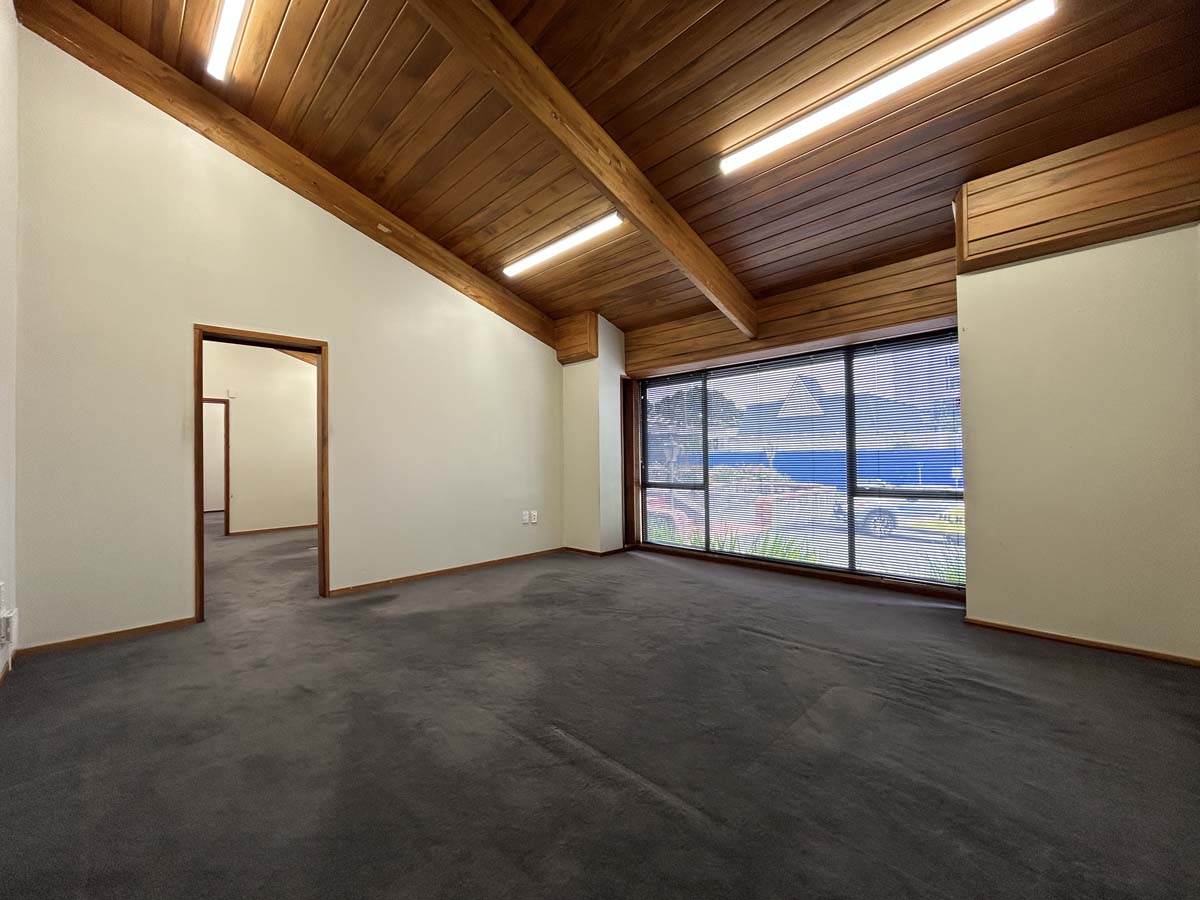 Modern office interior with wooden ceiling and large window at Powderham Business Centre.