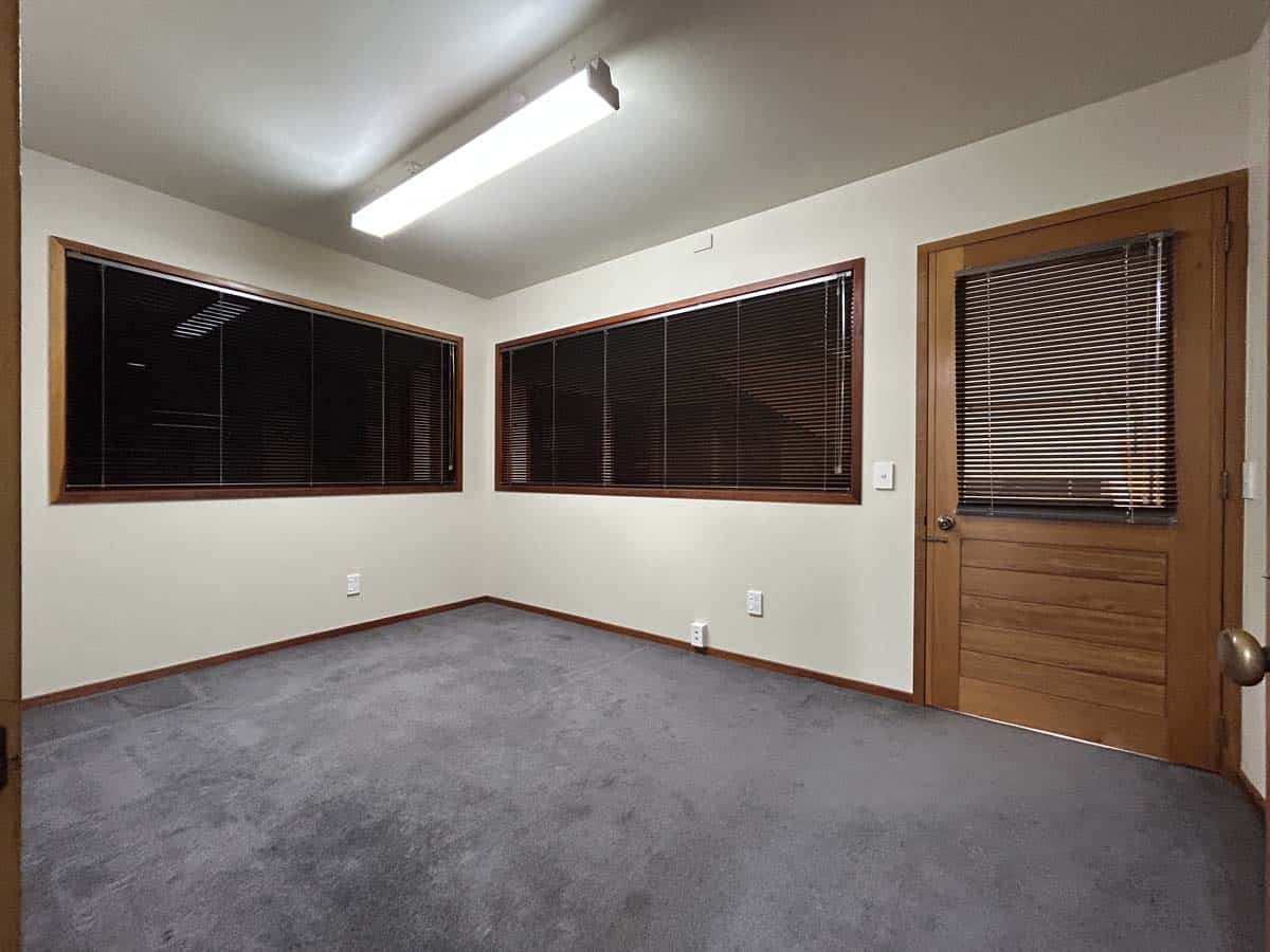 Modern office room with large windows and wooden door at Powderham Business Centre.