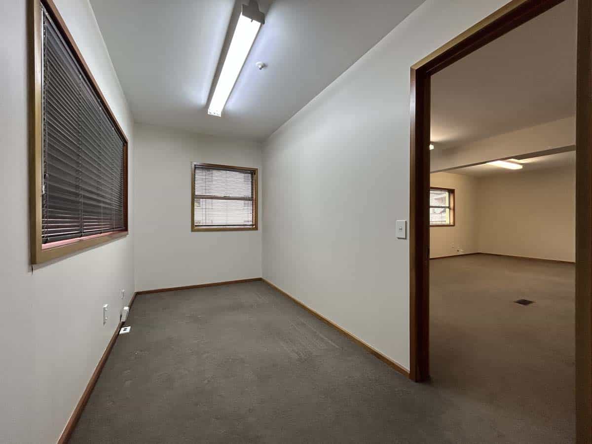 Bright office room with windows and neutral decor at Powderham Business Centre.