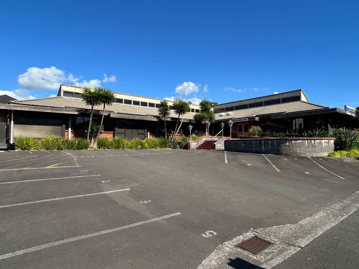 Modern White Lion building at Powderham Business Centre with parking area.