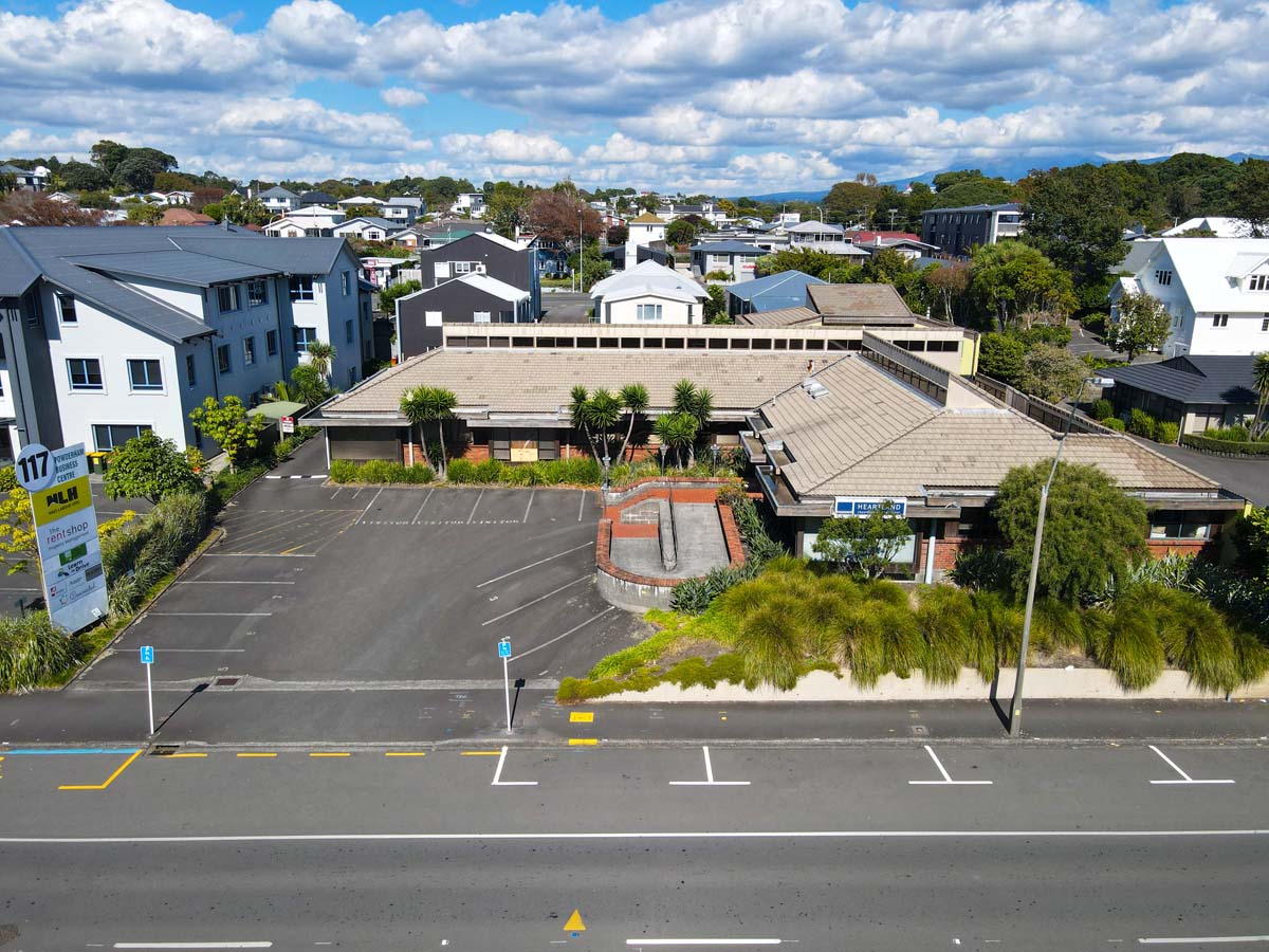 Modern commercial building at Powderham Business Centre with parking area.
