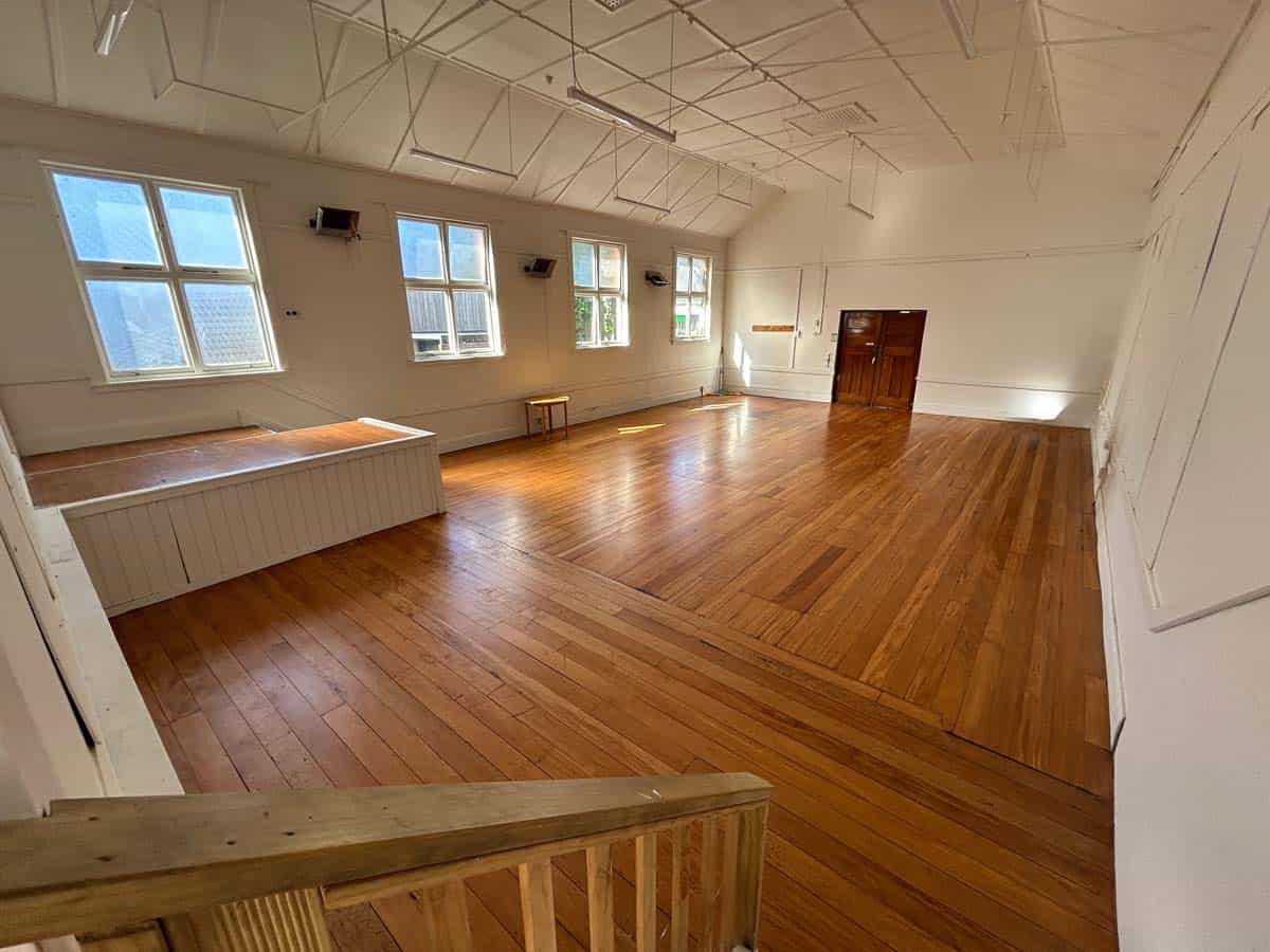Spacious interior of White Lion venue with wooden floors and large windows.