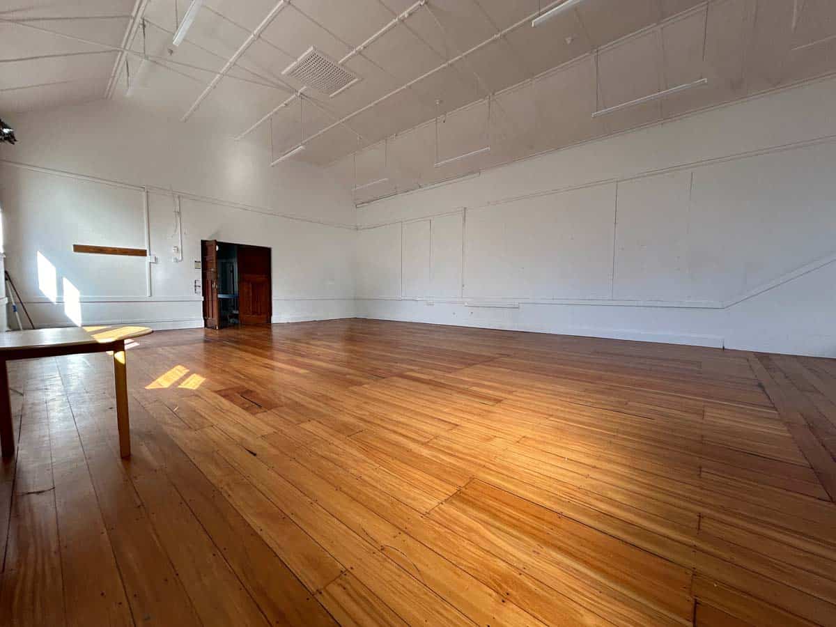 Spacious White Lion dance studio with polished wooden floors and high ceilings.