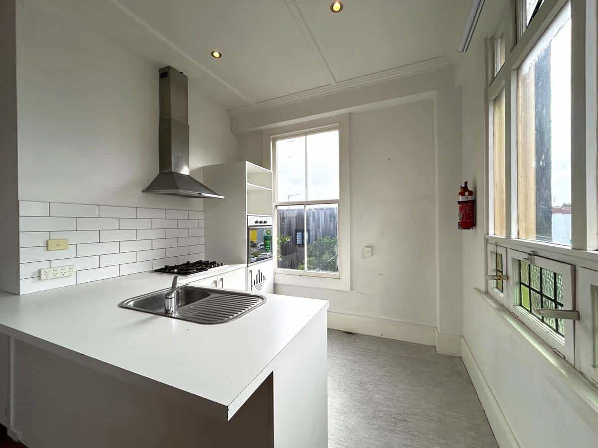 Bright and airy kitchen with white cabinetry and stainless steel appliances.