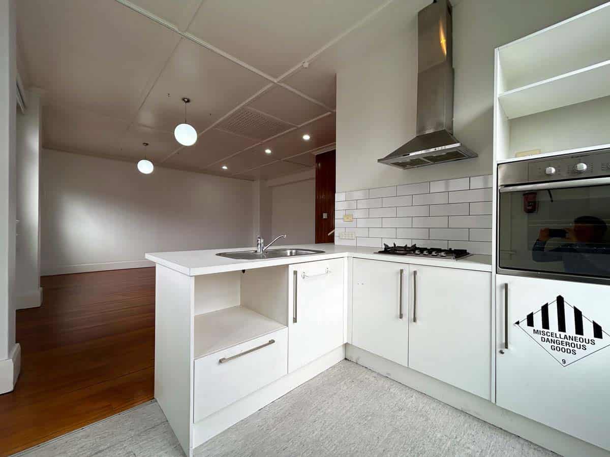 Bright modern kitchen with white cabinetry, stainless steel appliances, and a sleek design.