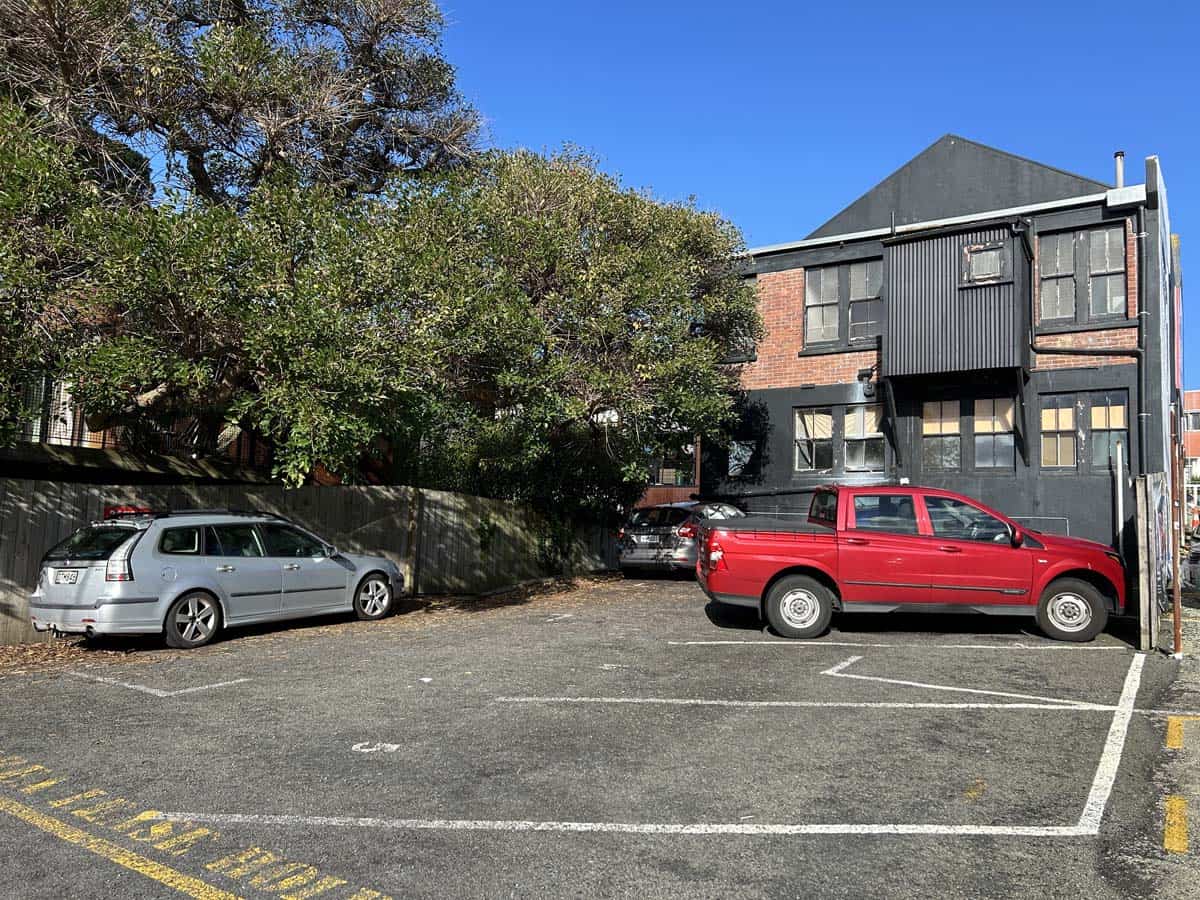 Parking lot with White Lion building at 74 Powderham Street, New Zealand.