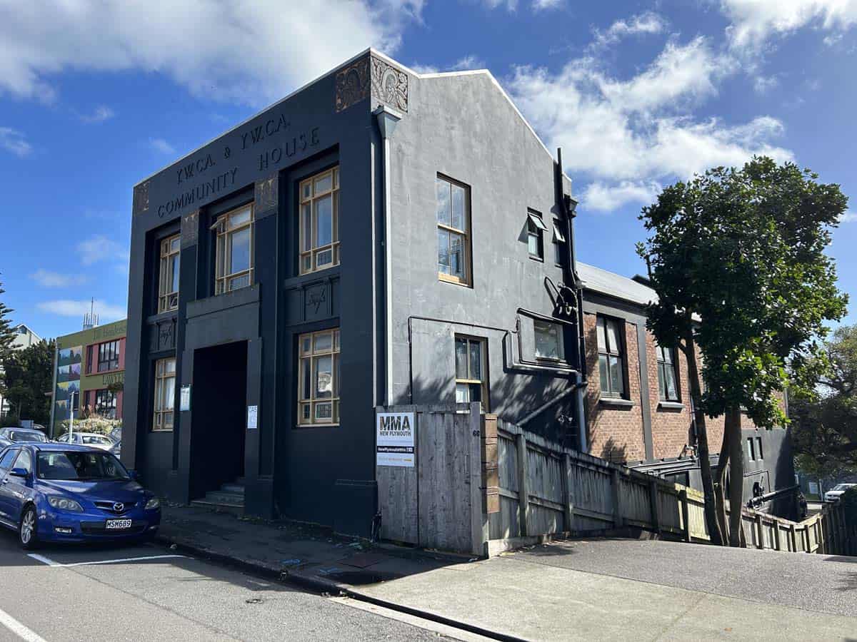 Exterior view of the White Lion Community YMCA building at 74 Powderham Street, featuring modern arc.