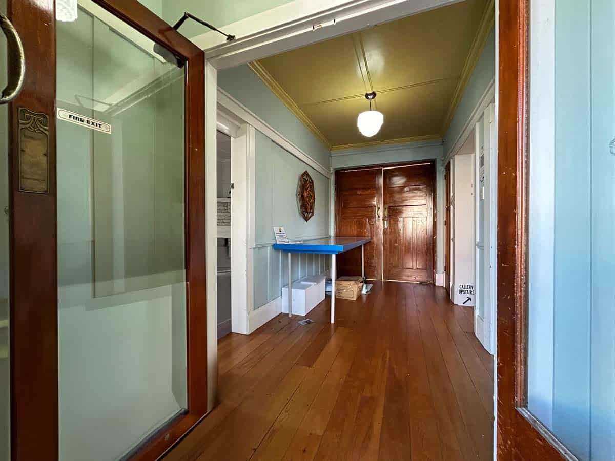 Interior view of the White Lion office at 74 Powderham Street, featuring vintage decor and wooden fl.