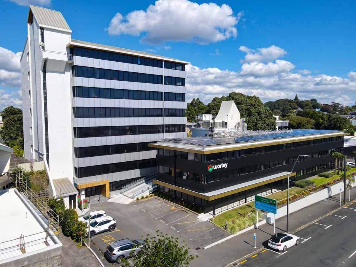 Modern office building with White Lion signage and parking area.