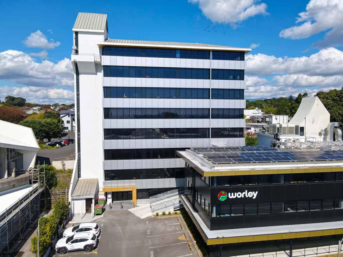 Modern office building with Worley branding and solar panels in New Zealand.