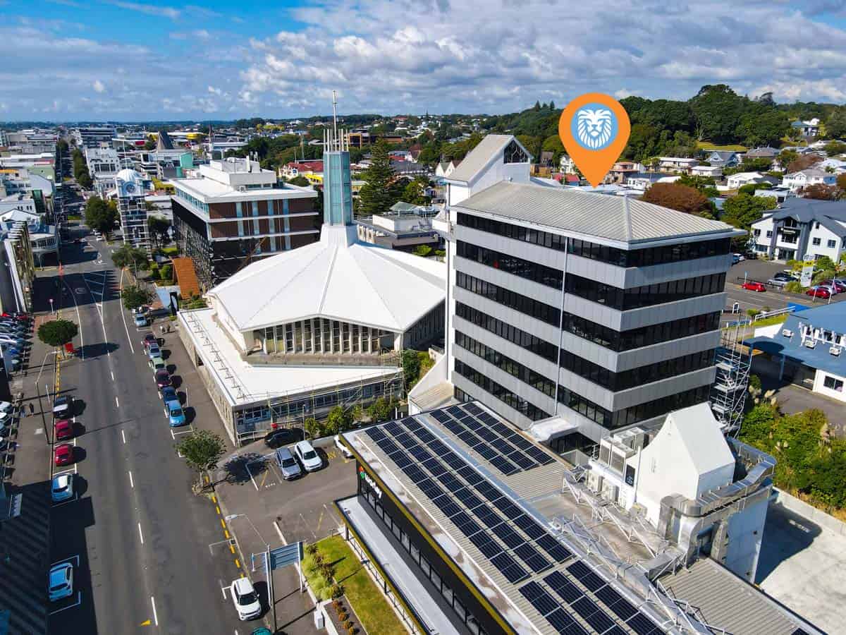 Aerial view of the White Lion building with cityscape and blue sky.