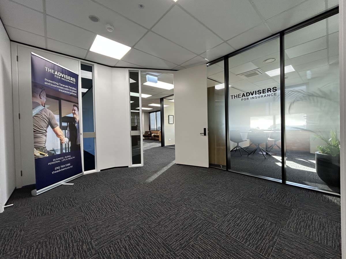 Modern office entrance with advisory signage and glass walls at White Lion.