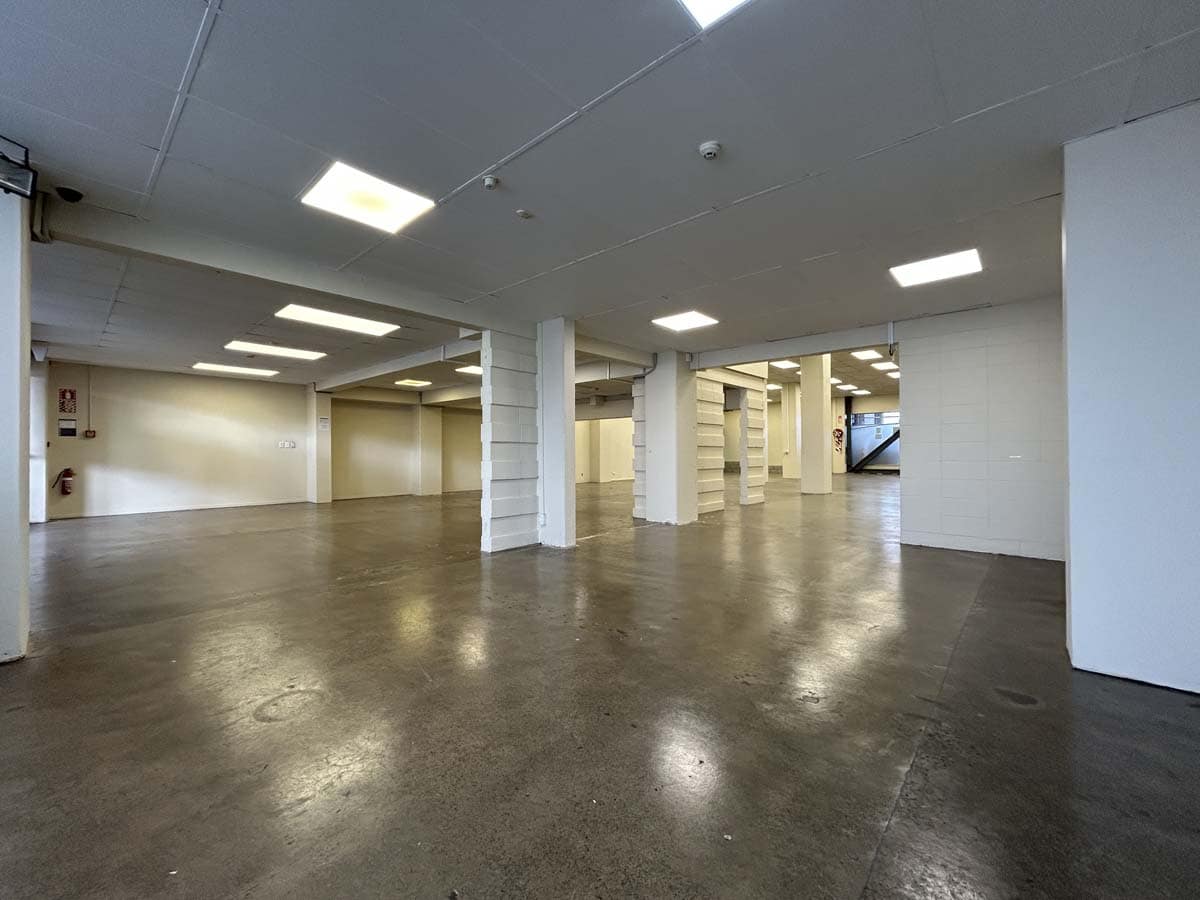Modern, open-plan commercial space with polished concrete floors and bright lighting.