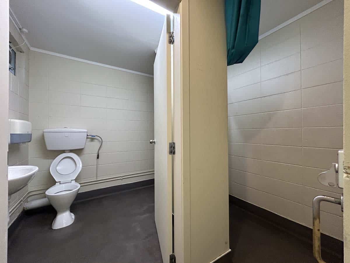 Public restroom with toilet and sink in a clean, accessible facility.