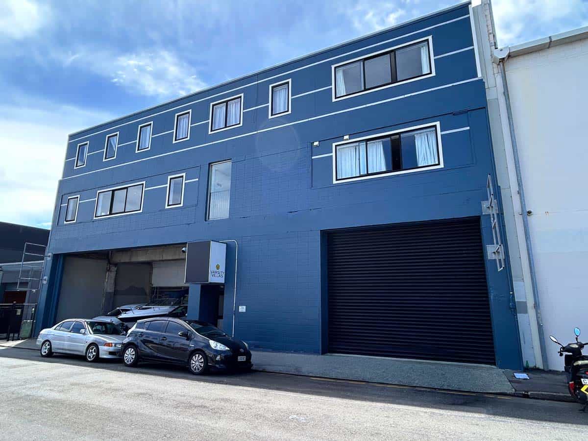 Modern blue commercial building with parking in Auckland CBD.