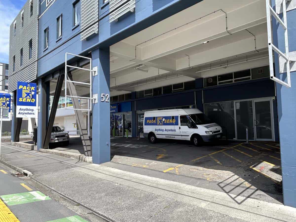 Delivery van with Pack & Send branding under building archway.