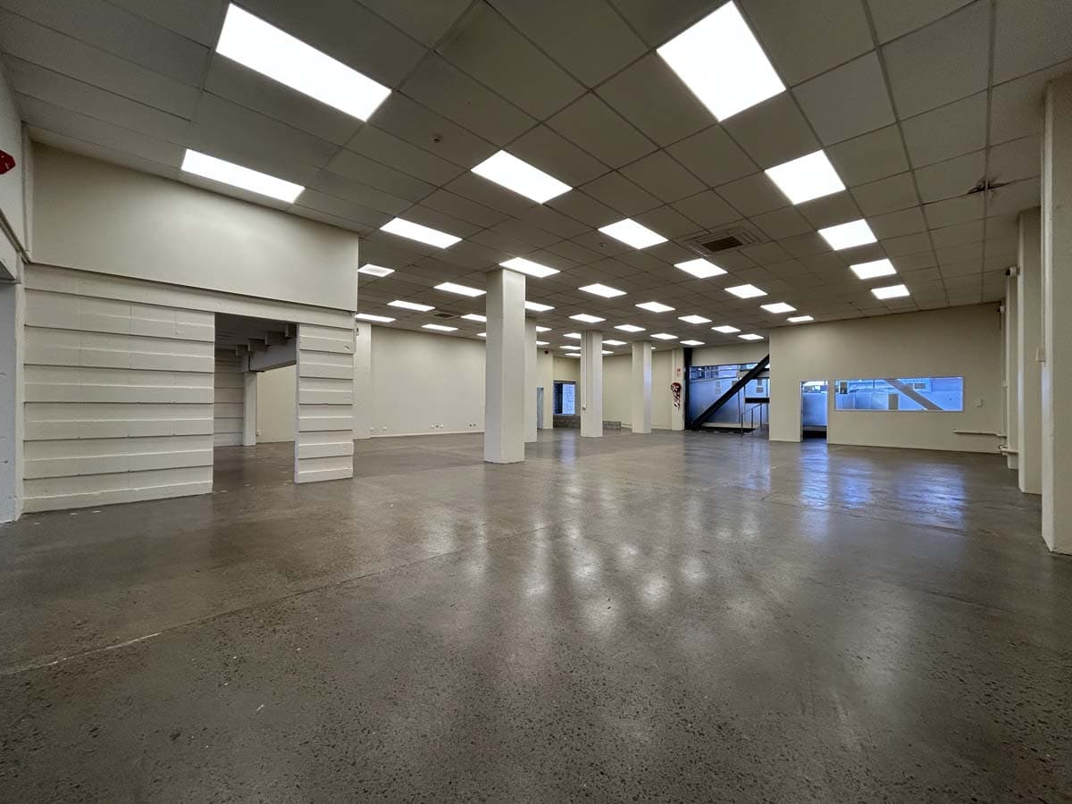 Spacious, modern commercial interior with high ceilings and ample lighting.