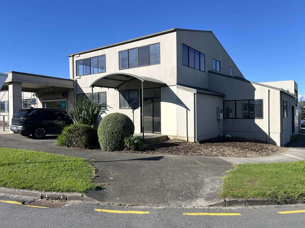 Modern commercial office building with contemporary design and large windows.