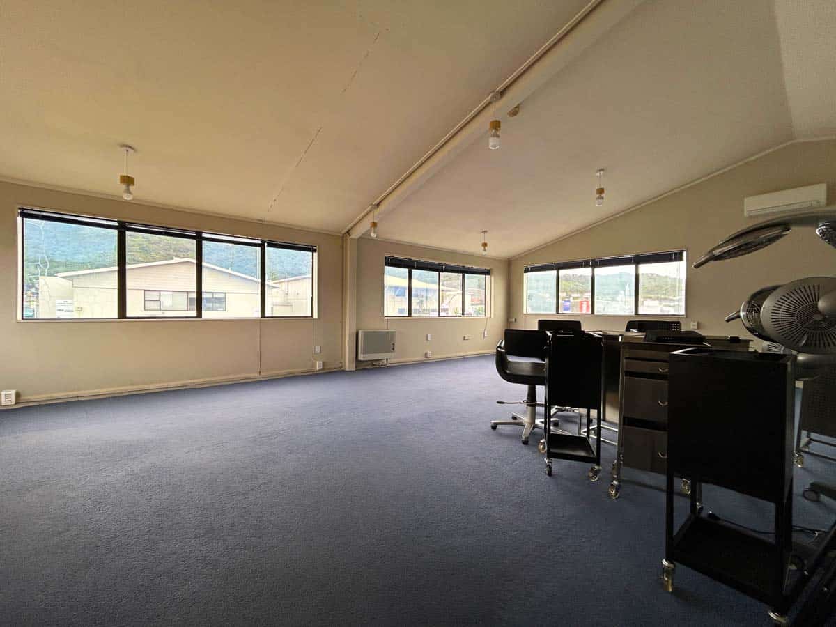 Office meeting room with large windows and modern furniture.