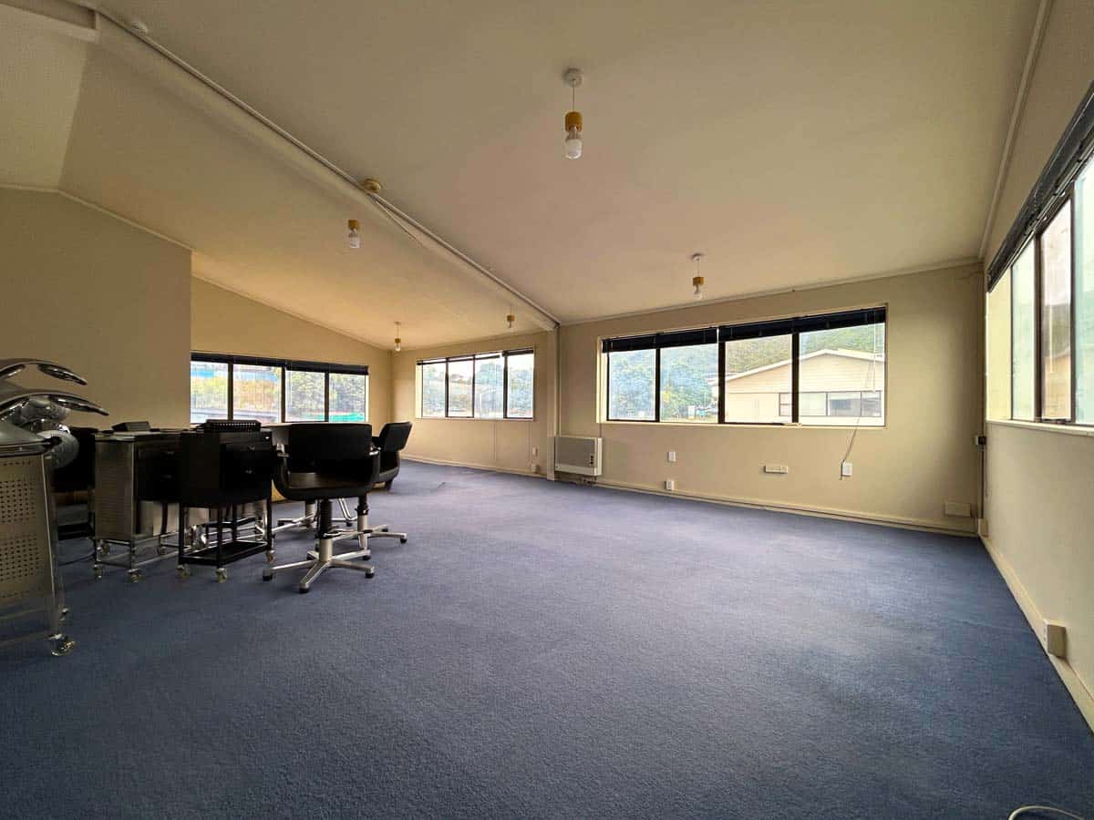 Spacious office with large windows and open-plan design for productivity.