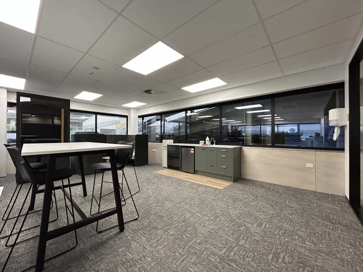 Bright, contemporary office interior with large windows and seating area.