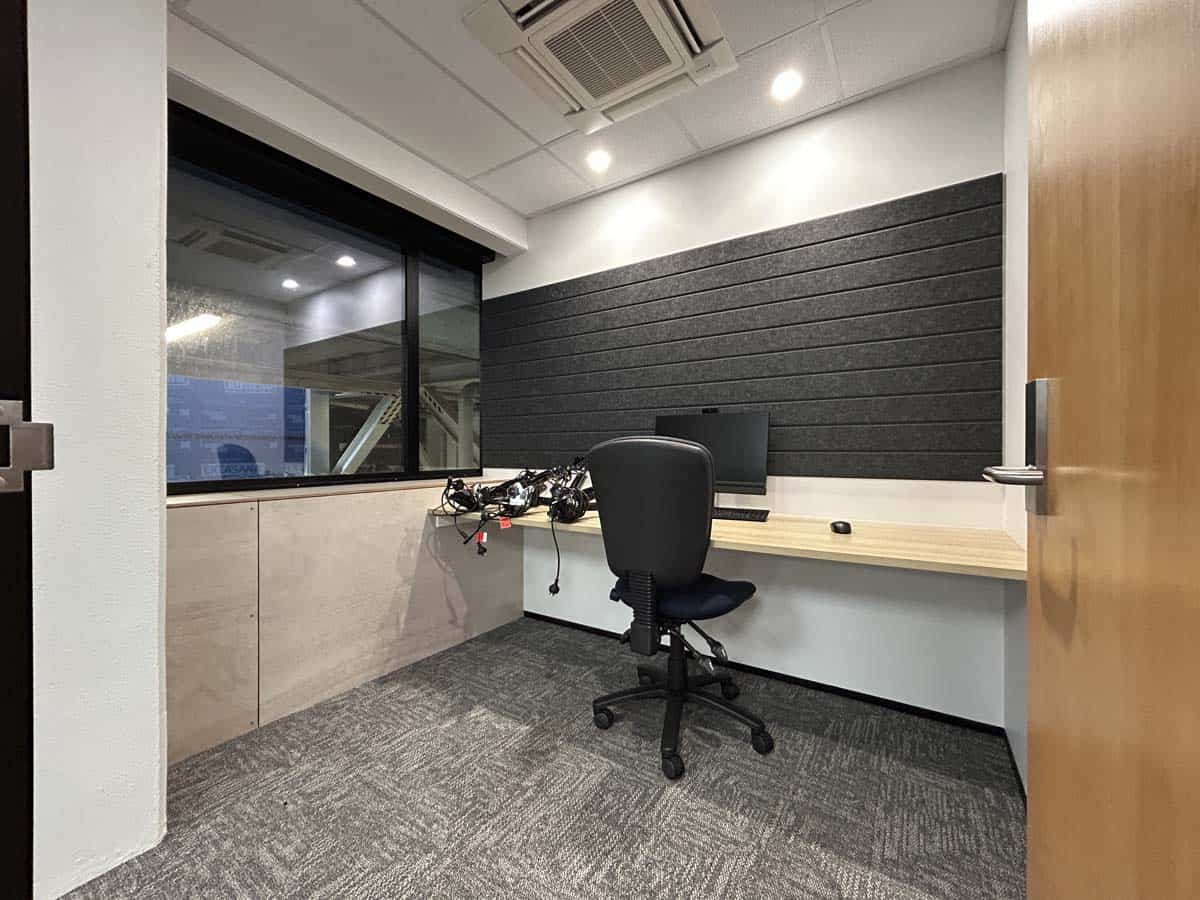 Modern office desk with chair and computer in a professional workspace.