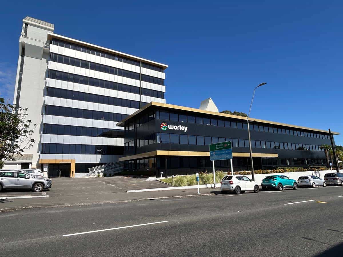 Modern office building in Auckland with White Lion branding and parking area.
