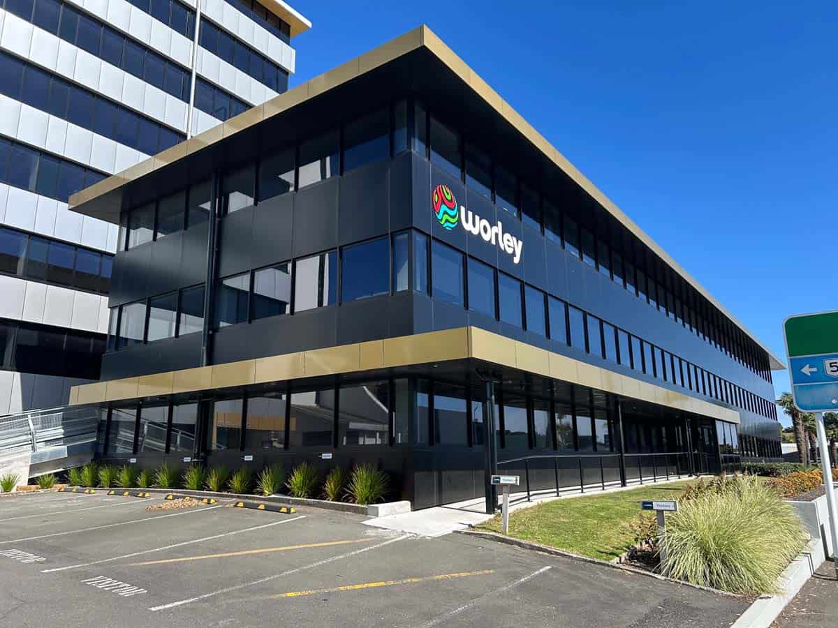 Modern Worley office building in New Zealand with glass facade and landscaping.