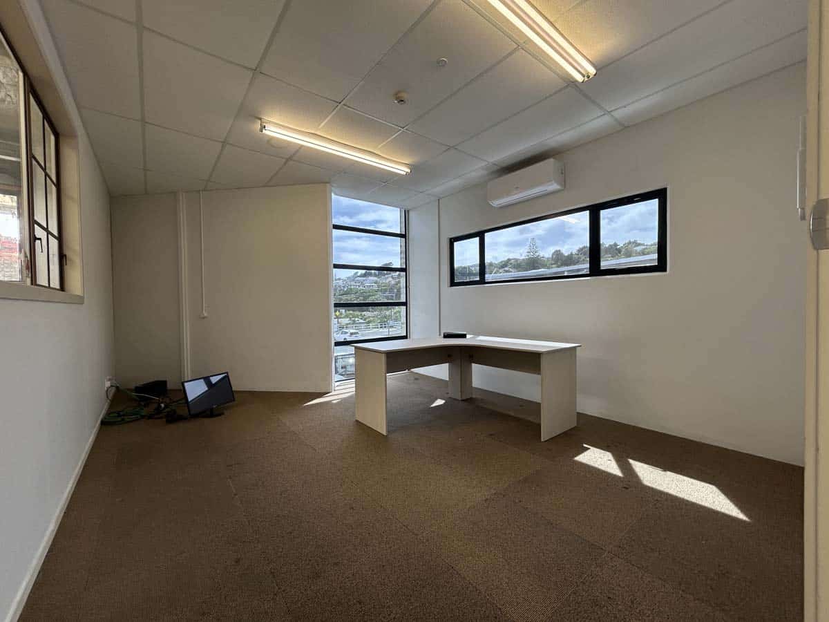Bright office space with large windows and modern lighting.