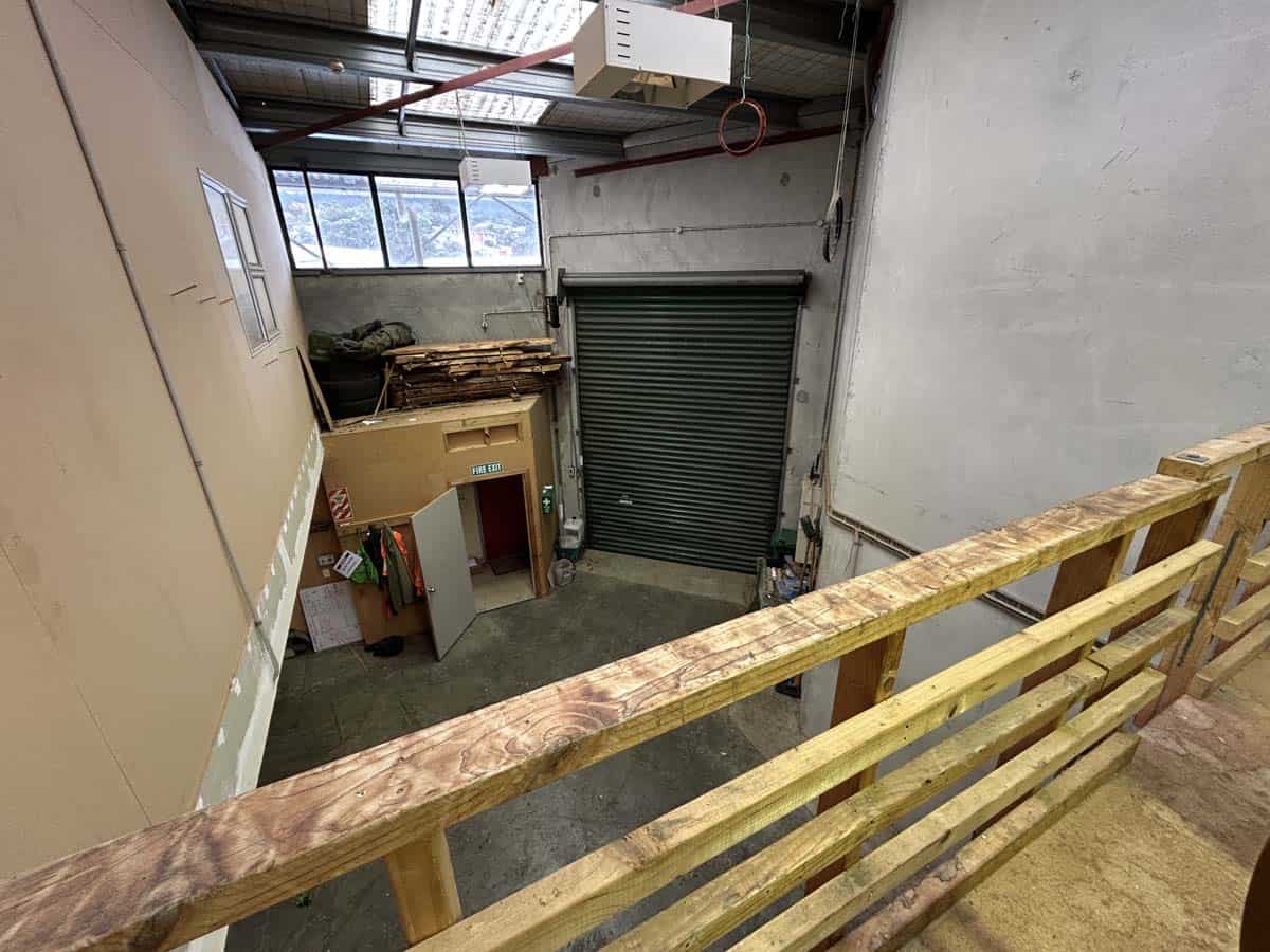 Indoor warehouse space with storage area and roller shutter door.