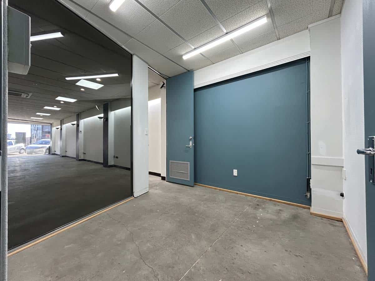 Modern office space with glass partition and blue accent wall at White Lion.