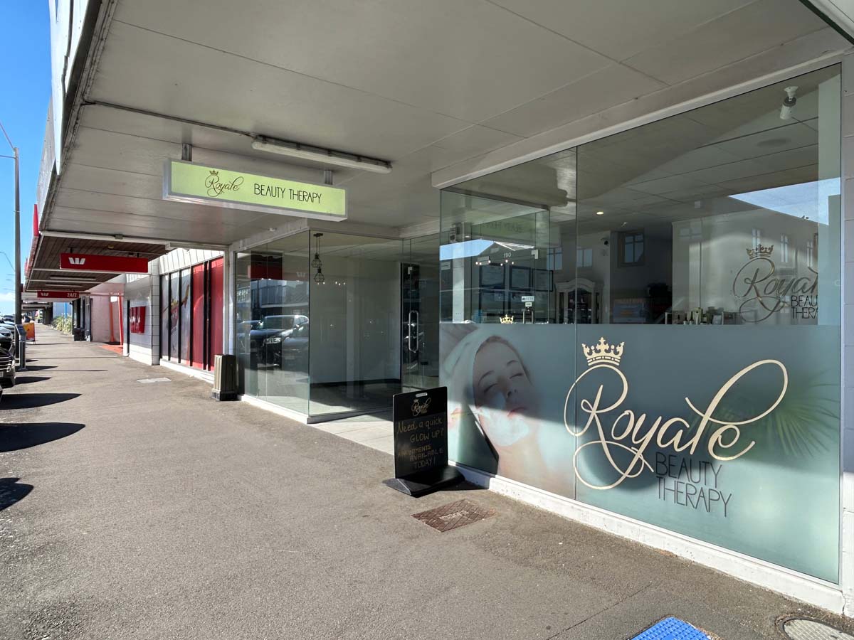 Exterior view of White Lion Beauty Therapy salon with large window display and signage.