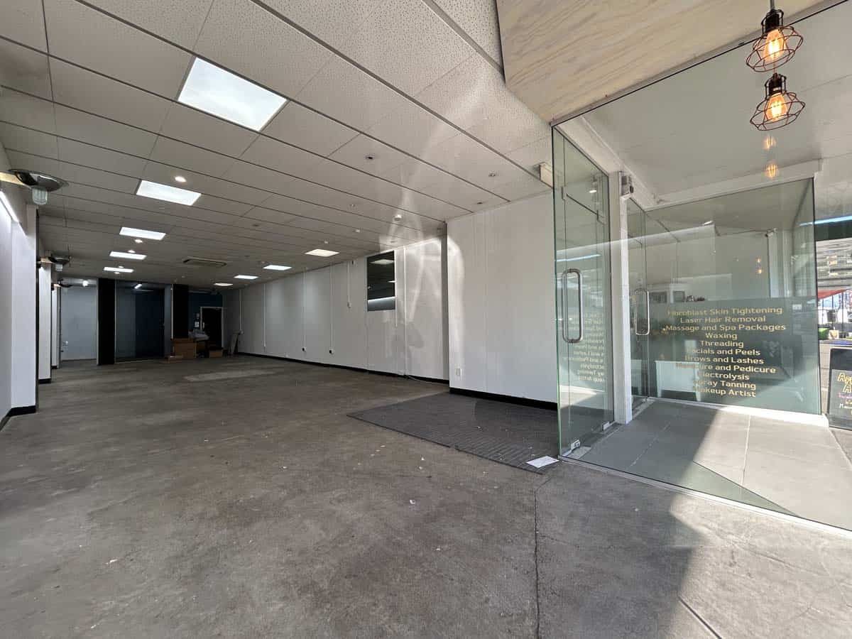 Modern office entrance with glass doors and contemporary lighting.