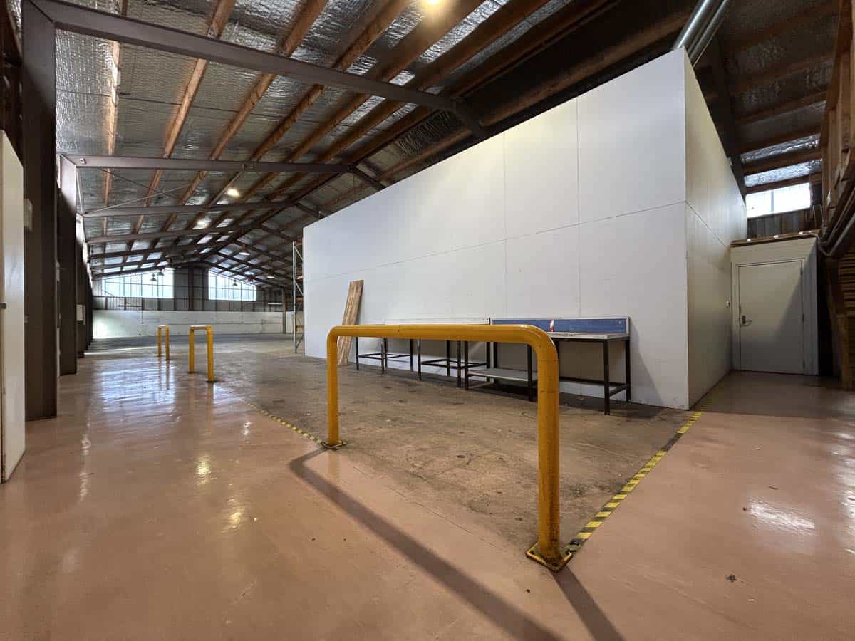 Interior of White Lion warehouse showing storage space and safety barriers.