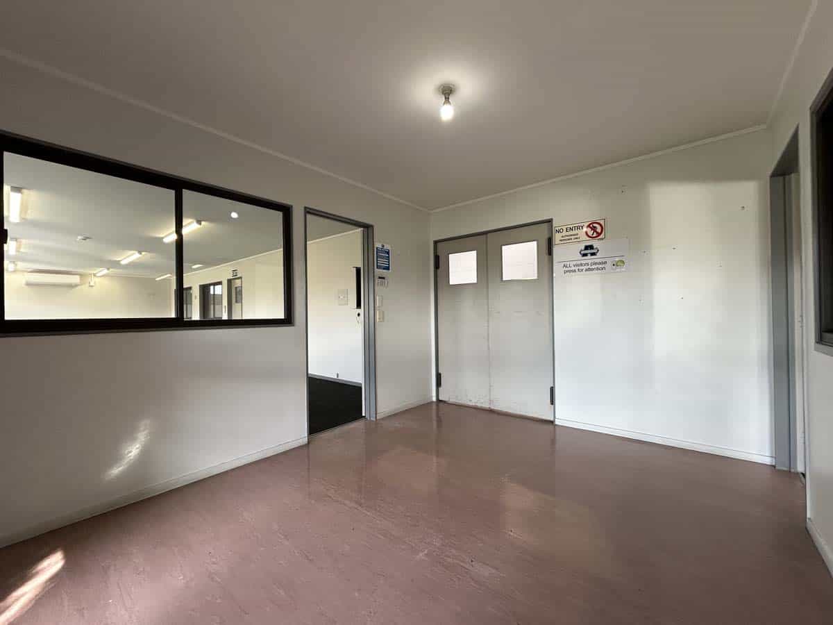 Modern office entrance with double doors and glass partition, suitable for business use.