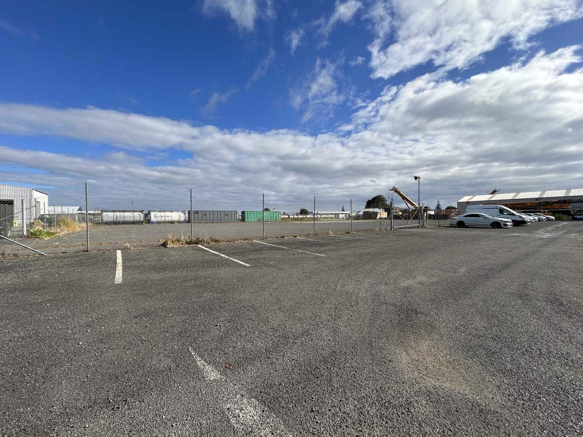 Empty parking lot with trucks and blue sky at White Lion site.
