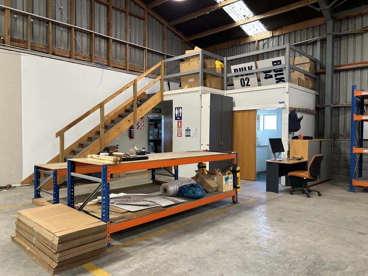 White Lion warehouse workspace with storage mezzanine and office area for industrial storage.