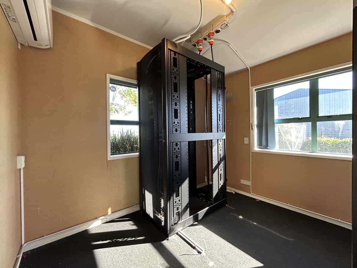 Server rack installed in a room with natural light and beige walls.