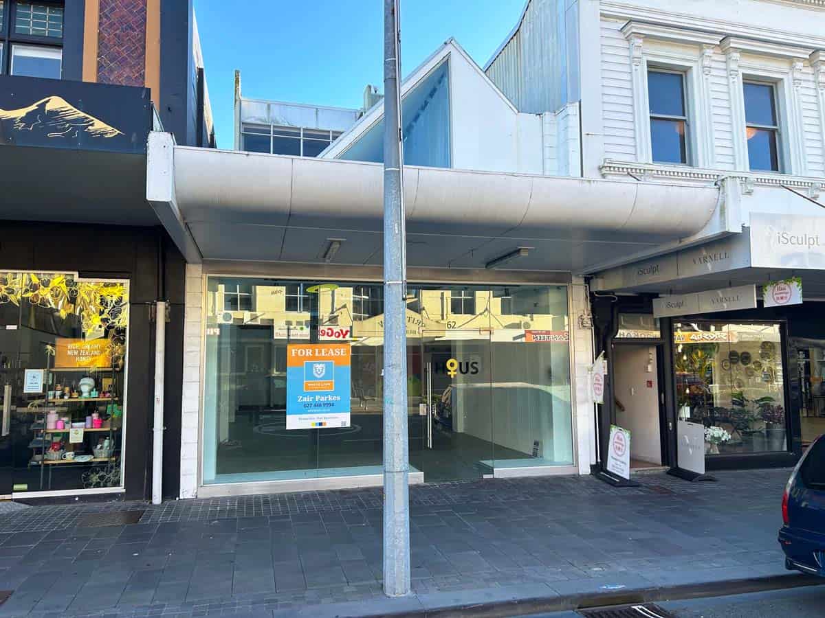 Empty commercial storefront in Auckland city center with "For Lease" sign.