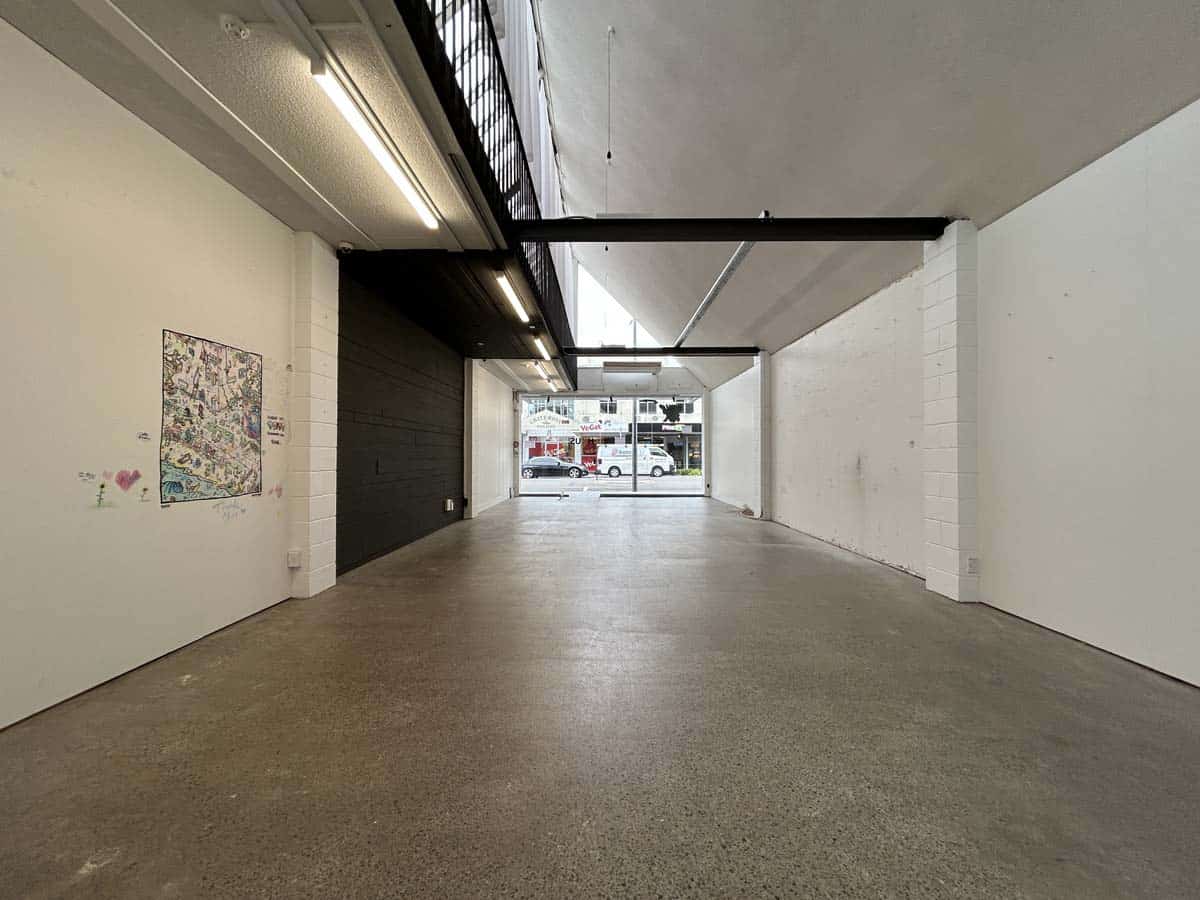 Modern art gallery interior with white walls and artwork display.