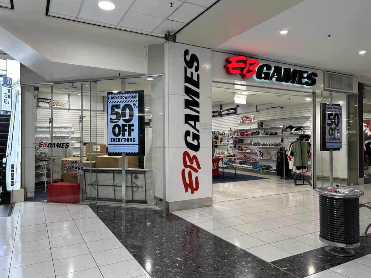 Modern EB Games store inside a shopping mall with gaming products and signage.