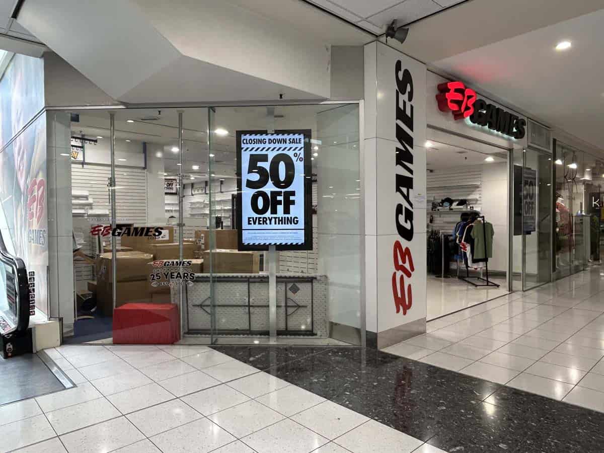 White Lion gaming store entrance with 50% off closing sale sign in shopping mall.