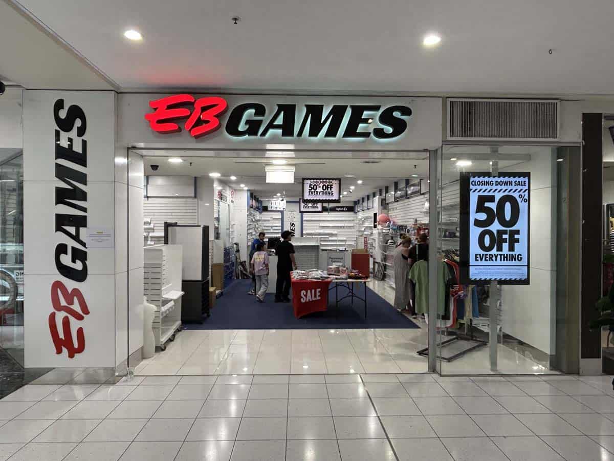 EB Games store entrance with sale signage and 50% off promotion.
