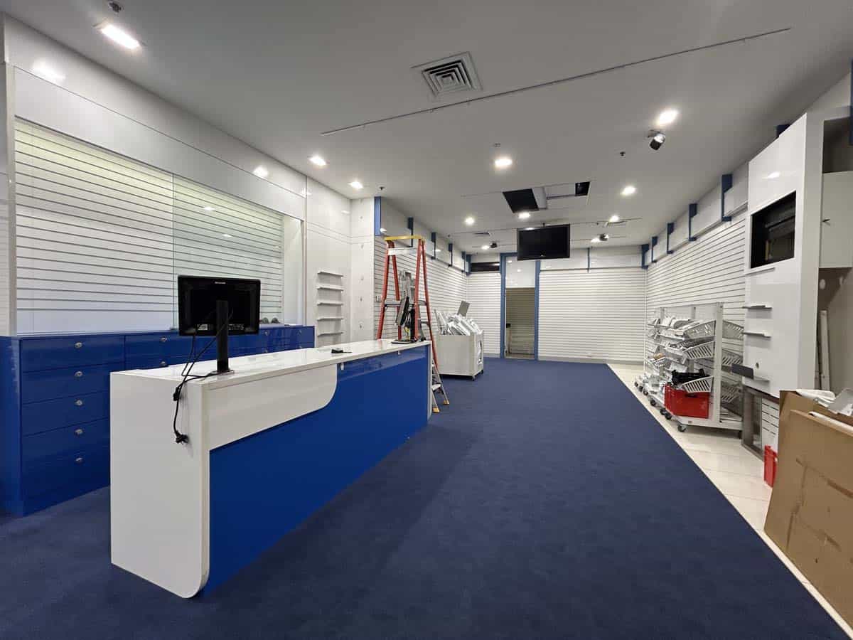 Interior of White Lion retail store featuring checkout counter and product shelves.