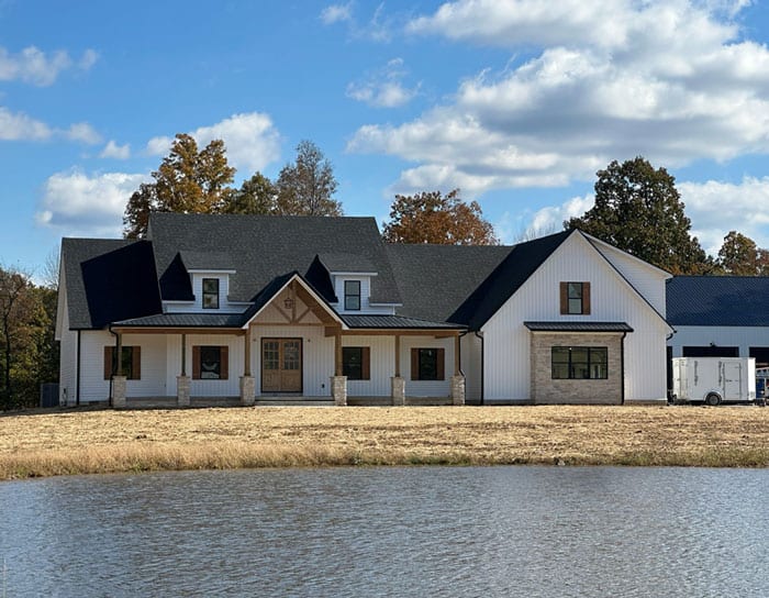 Built house with a scenic water backdrop and lush trees. Perfect for luxury living and outdoor enjoy.