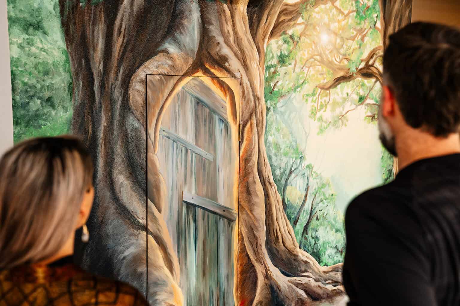 A family looks on at their new magic forest mural
