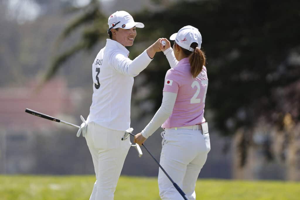 SAN FRANCISCO, CALIFORNIA - MAY 04: Yuka Saso (L) and Ayaka Furue (R) of Team Japan fist bump after a putt on the 11th green during day one of the Hanwha LIFEPLUS International Crown at TPC Harding Park on May 04, 2023 in San Francisco, California. (Photo by Mike Mulholland/Getty Images)